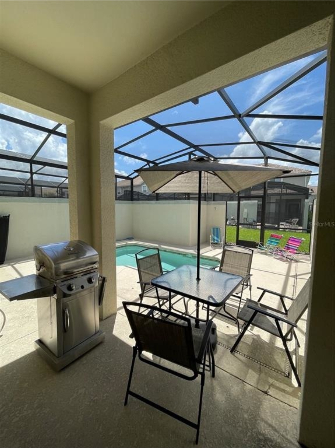 Covered patio with pool view and outdoor seating